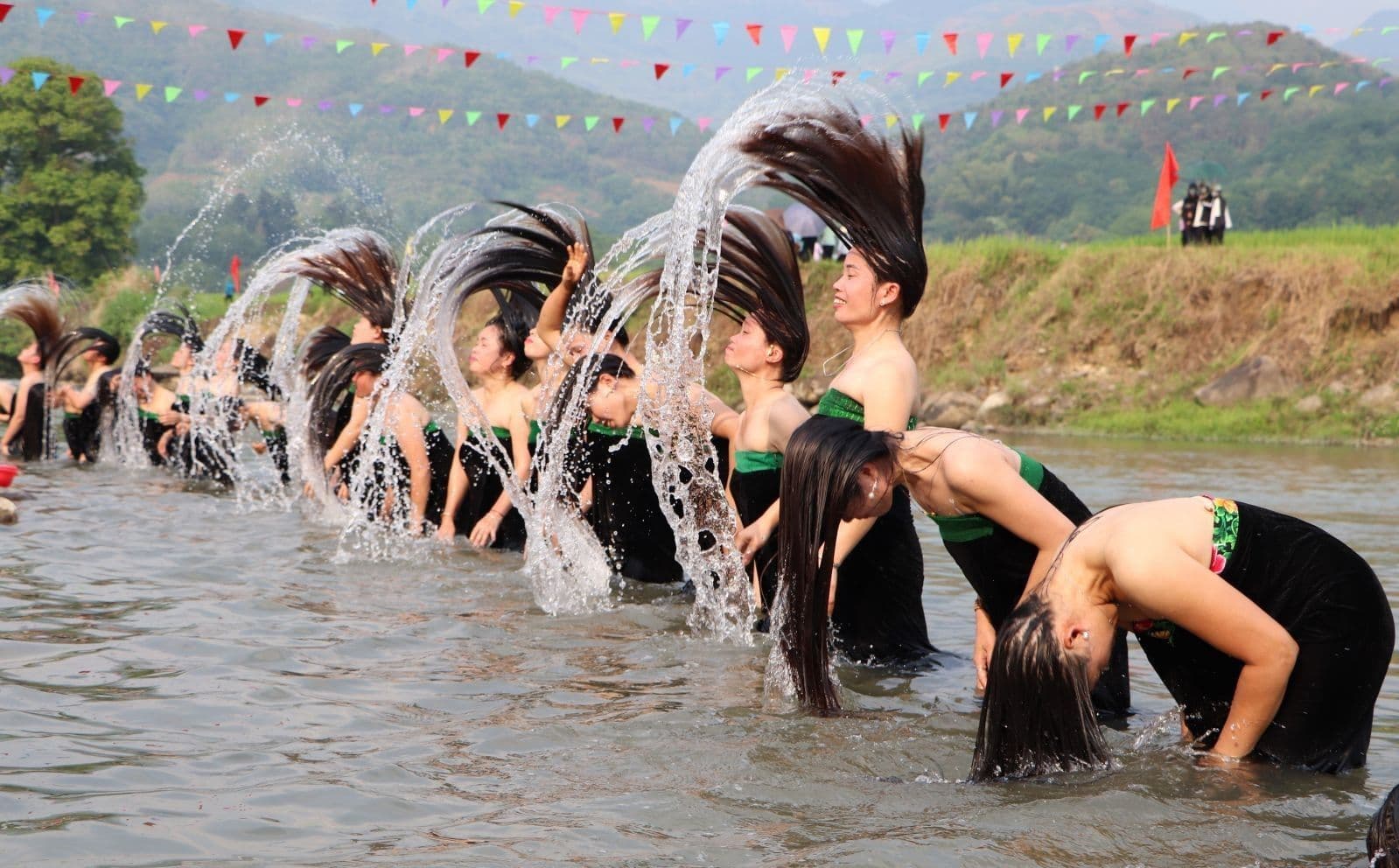 Thai ethnic women wash their hair at the Nam Lum stream during the Ap Ho gong festival